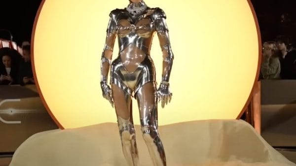Zendaya at premiere standing in sand wearing metallic robot suit